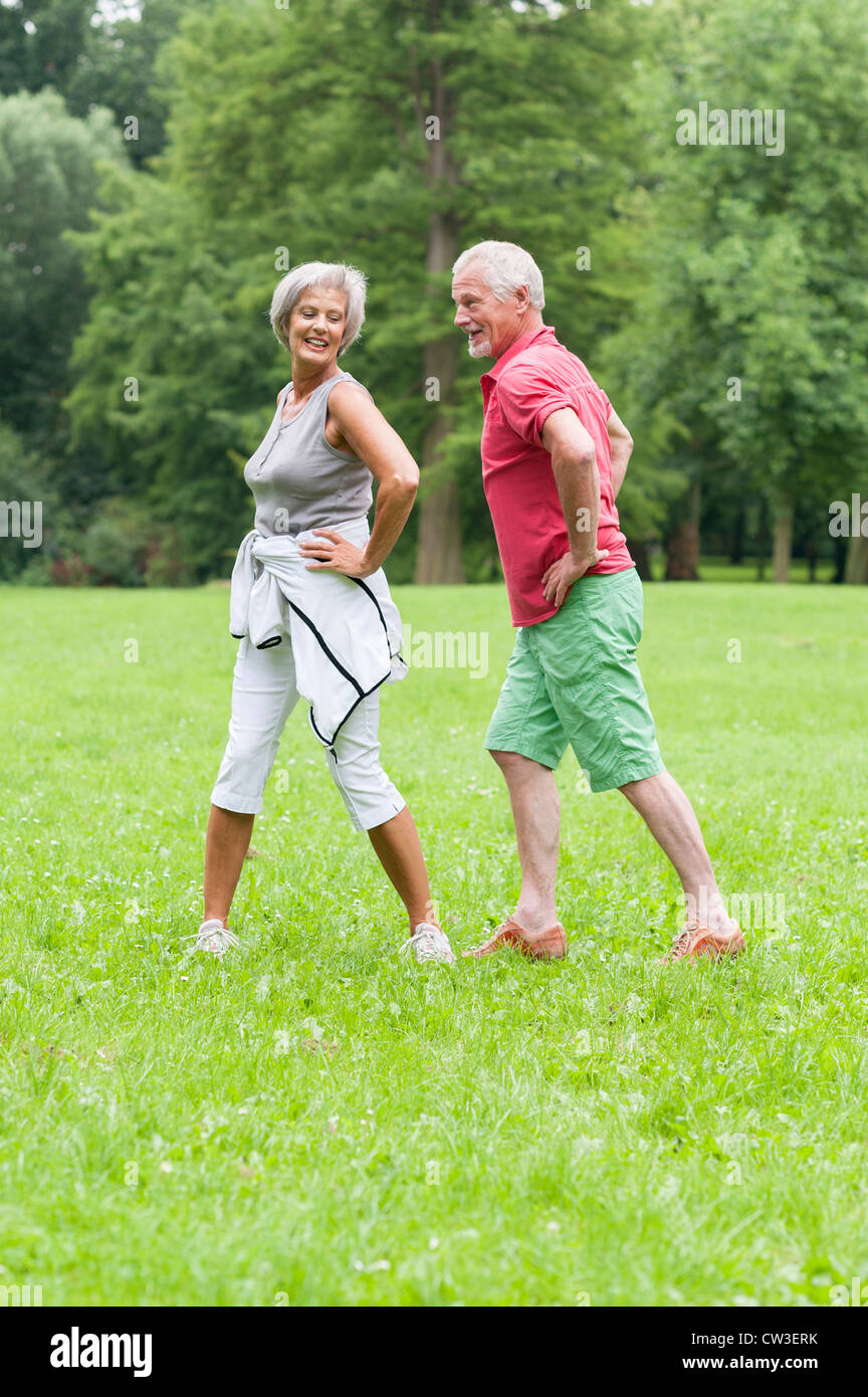 Active senior couple in the park doing gymnastics Stock Photo - Alamy