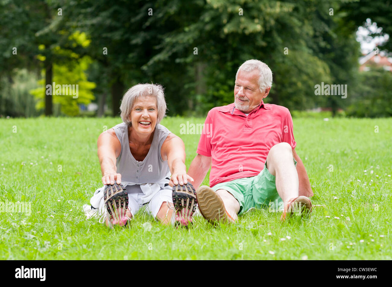 Active senior couple in the park doing gymnastics Stock Photo - Alamy