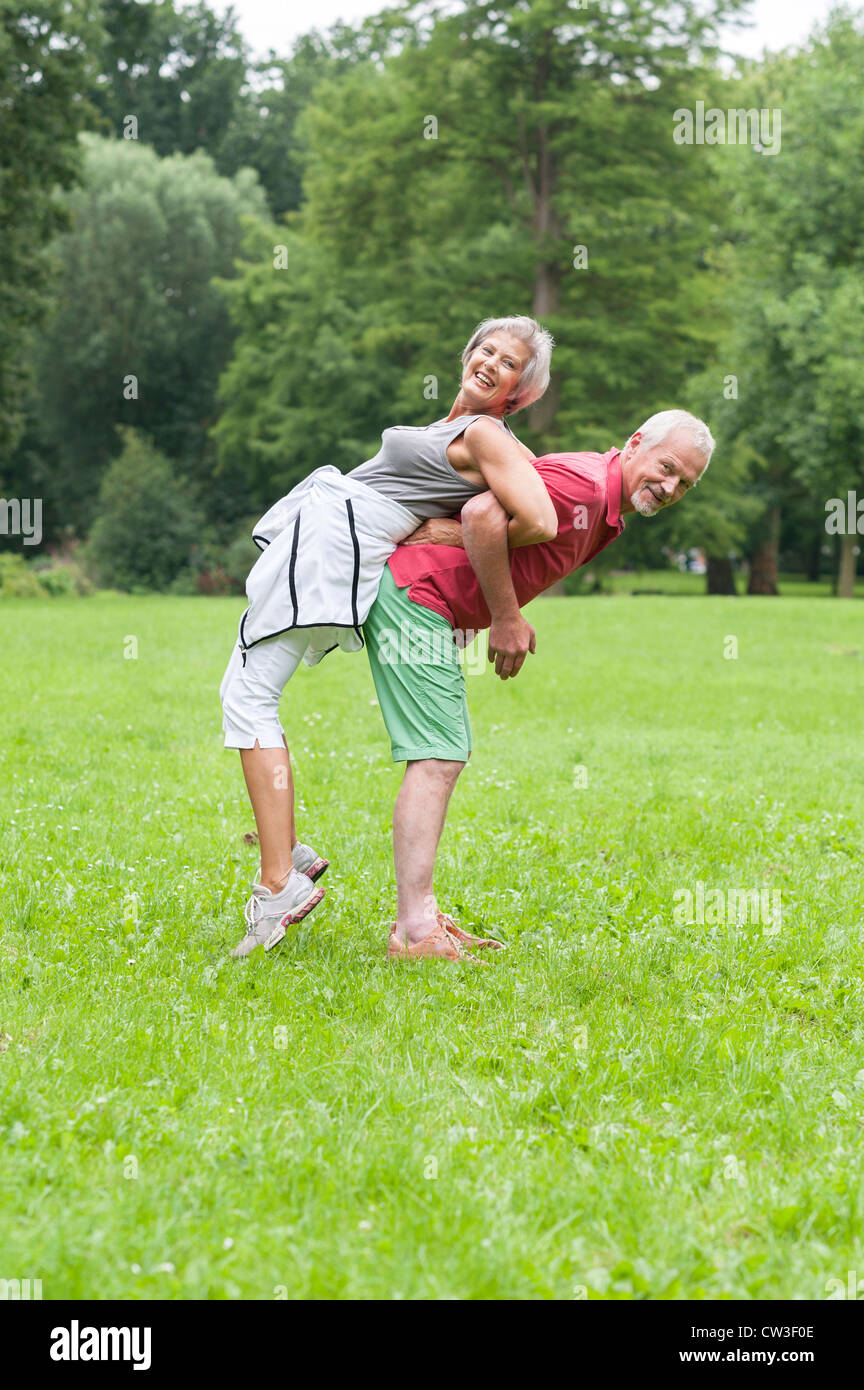 Active senior couple in the park doing gymnastics Stock Photo - Alamy