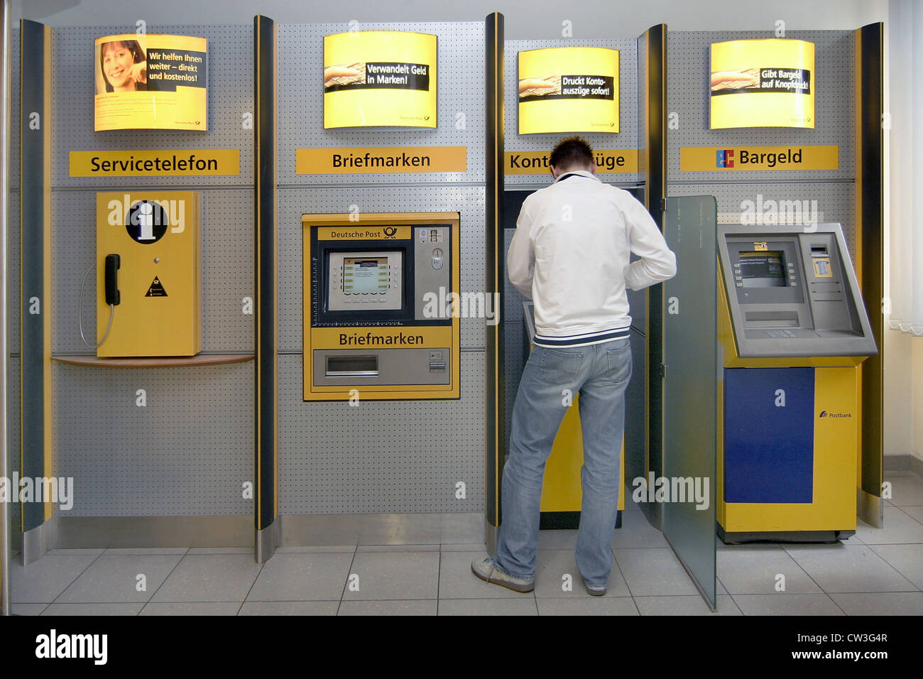 Man in a post office in a statement machines Stock Photo