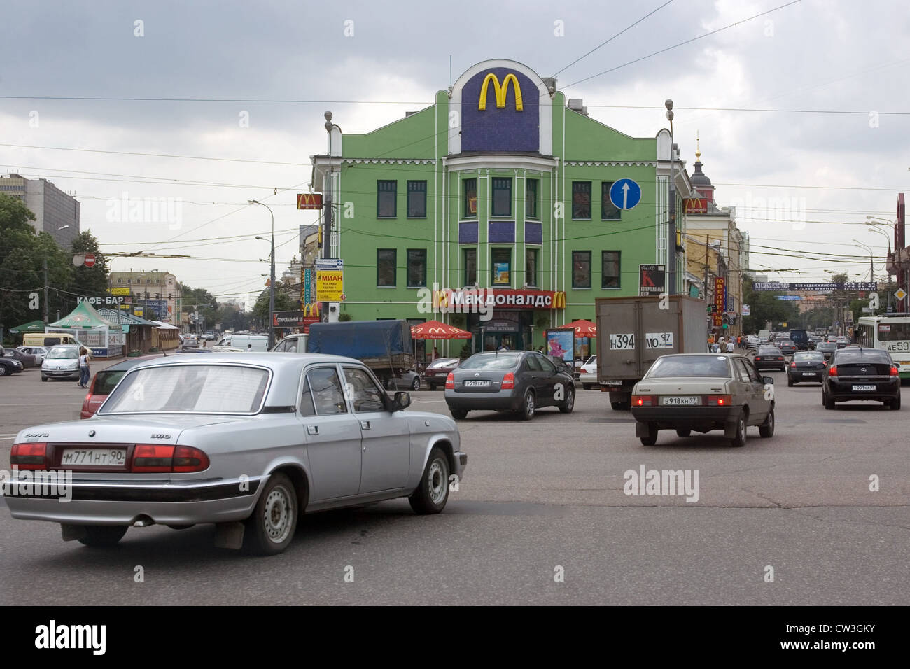 Moscow traffic in Moscow. In the background, a branch of McDonalds Stock Photo