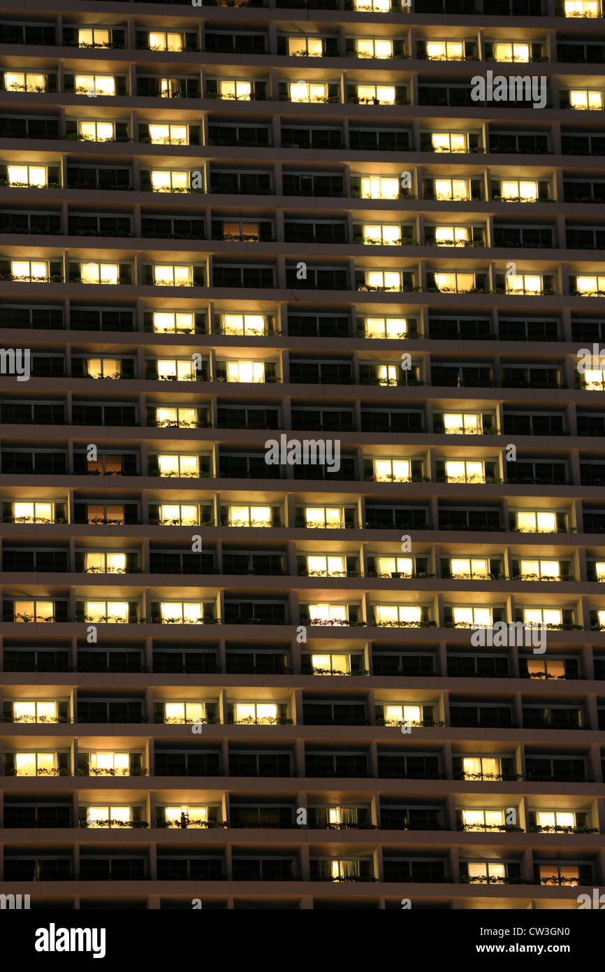 Illuminated hotel room windows at Marina Bay Sands luxury five star hotel in Singapore. Stock Photo