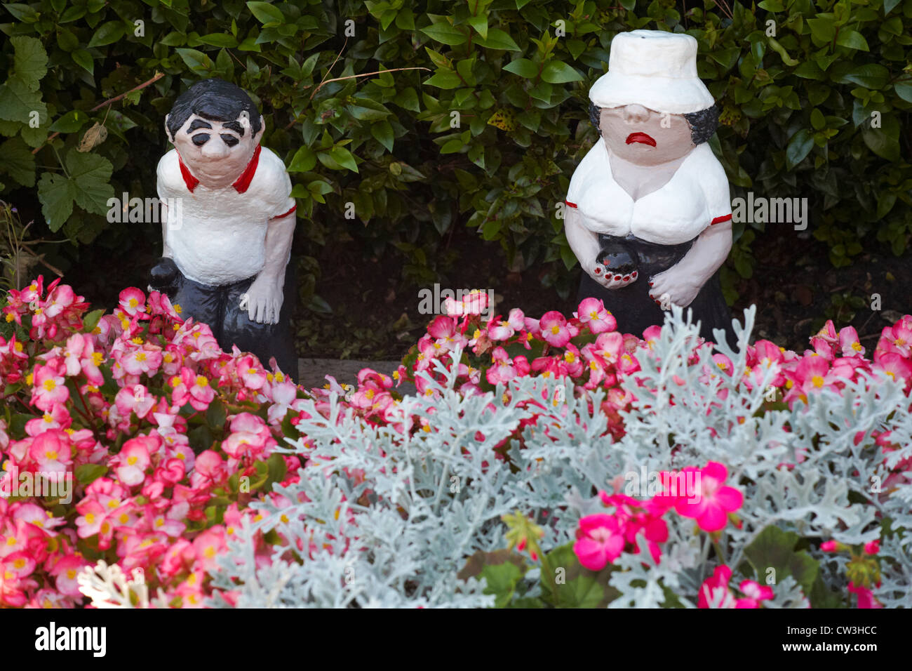 Bowlers garden ornaments positioned in flower bed at Bowling Club Stock Photo