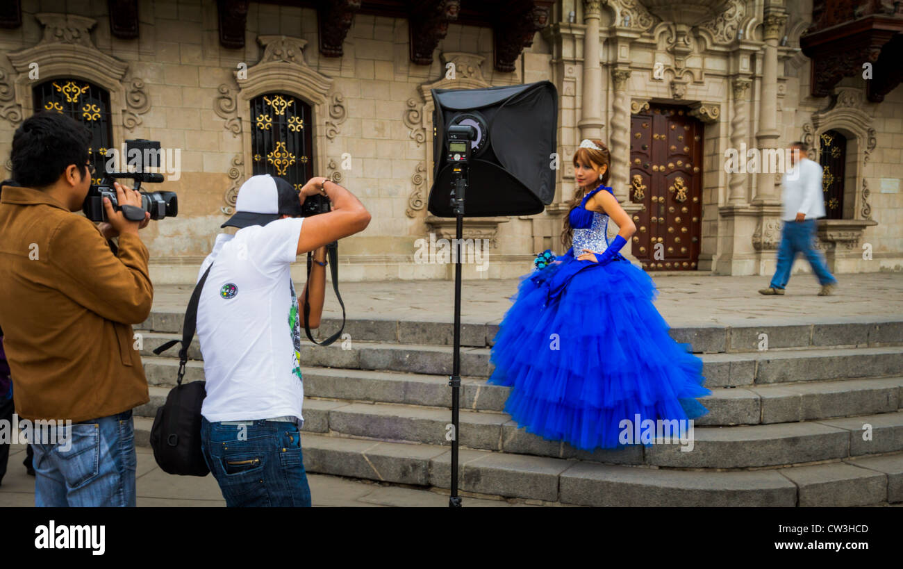 Local girl in gown has her portrait taken on the steps of Lima Cathedral. Stock Photo