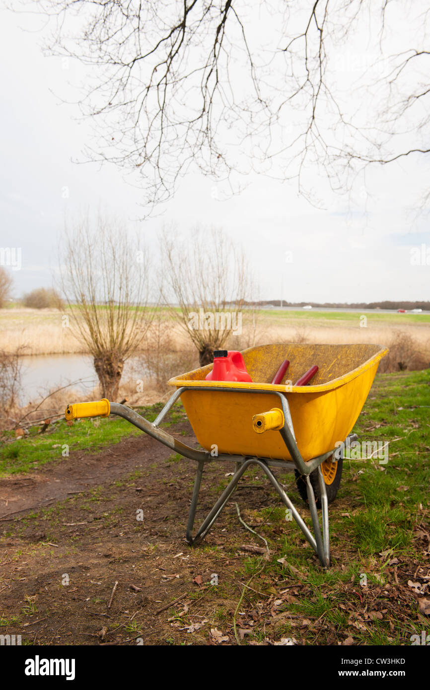 Yellow wheelbarrow from the gardener Stock Photo Alamy