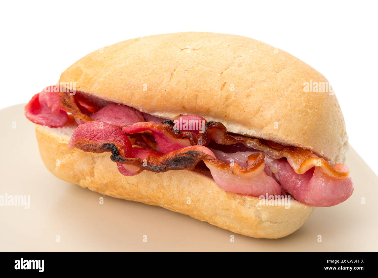 Crispy bacon in a bread roll - shallow depth of field - studio shot with a white background Stock Photo