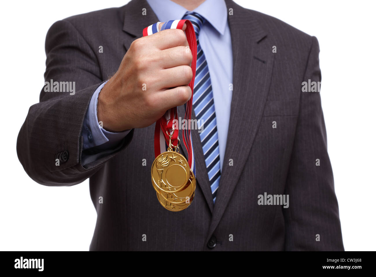 Businessman holding gold medal Stock Photo