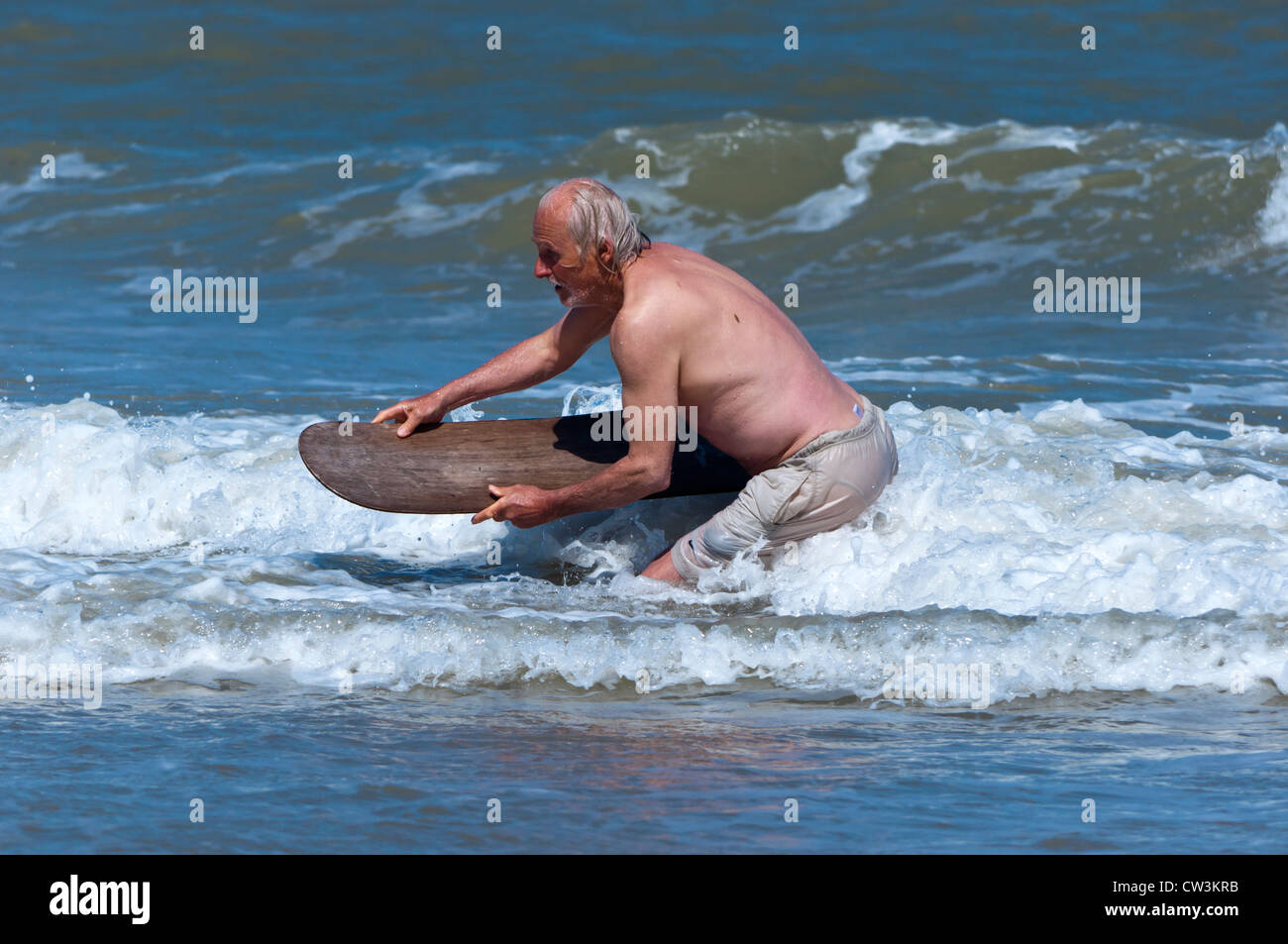 male pensioner body boarding Stock Photo