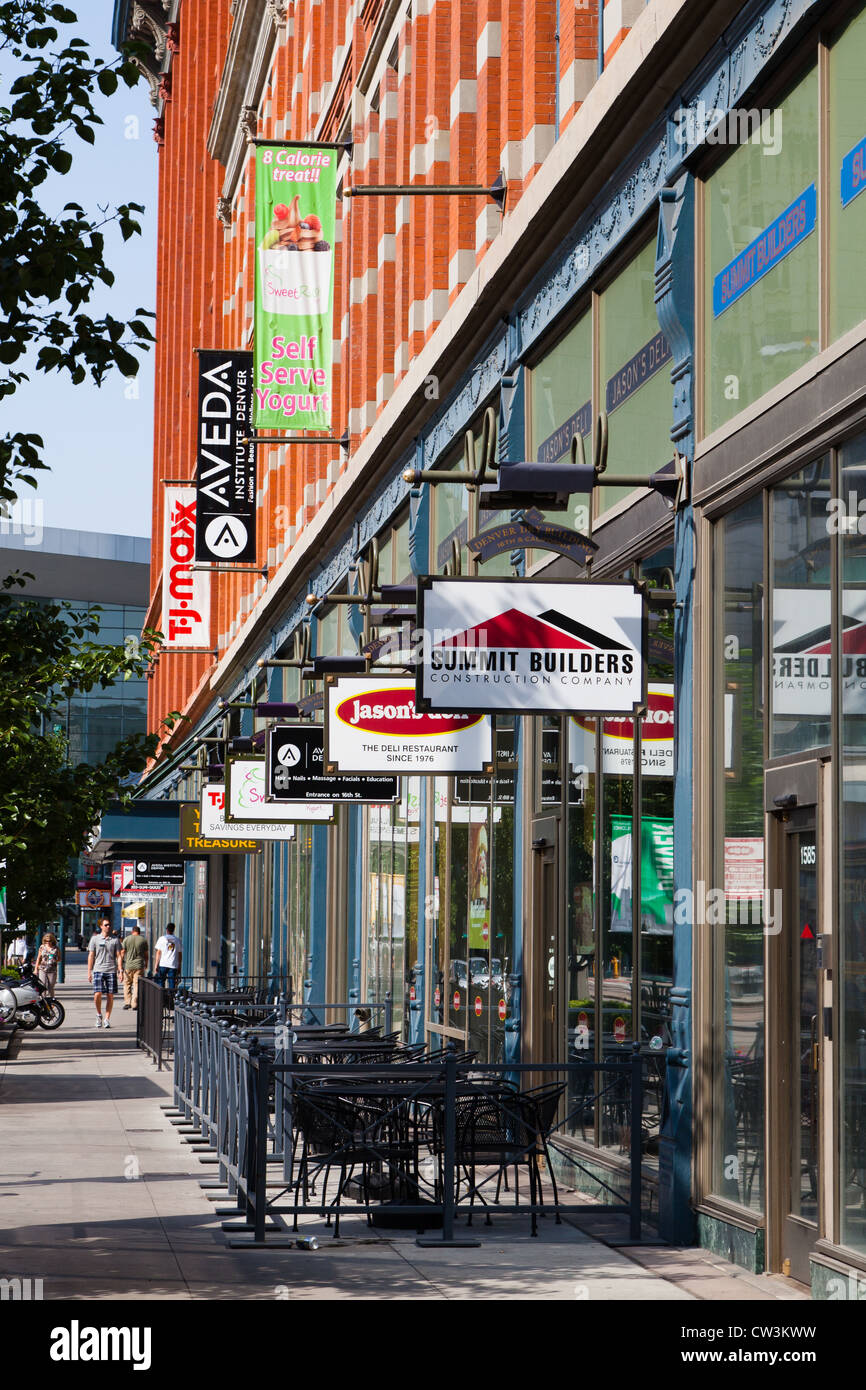The store fronts and hanging signs on Stout Street between 15th and