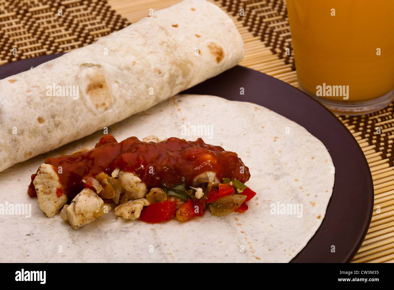 Burritos with chicken pepper onion garlic and sauce Stock Photo Alamy