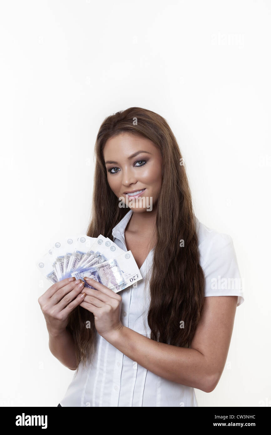 young attractive woman holding a hand full of english back notes Stock ...