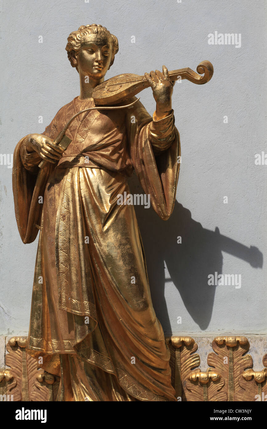 Gilded sculpture of a musician that stands at the walls of the Chinese House,a garden pavilion in the Sanssouci Park in Potsdam. Stock Photo