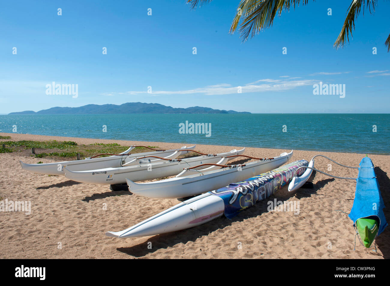Outrigger canoes resting on the sands of The Strand, main beach of