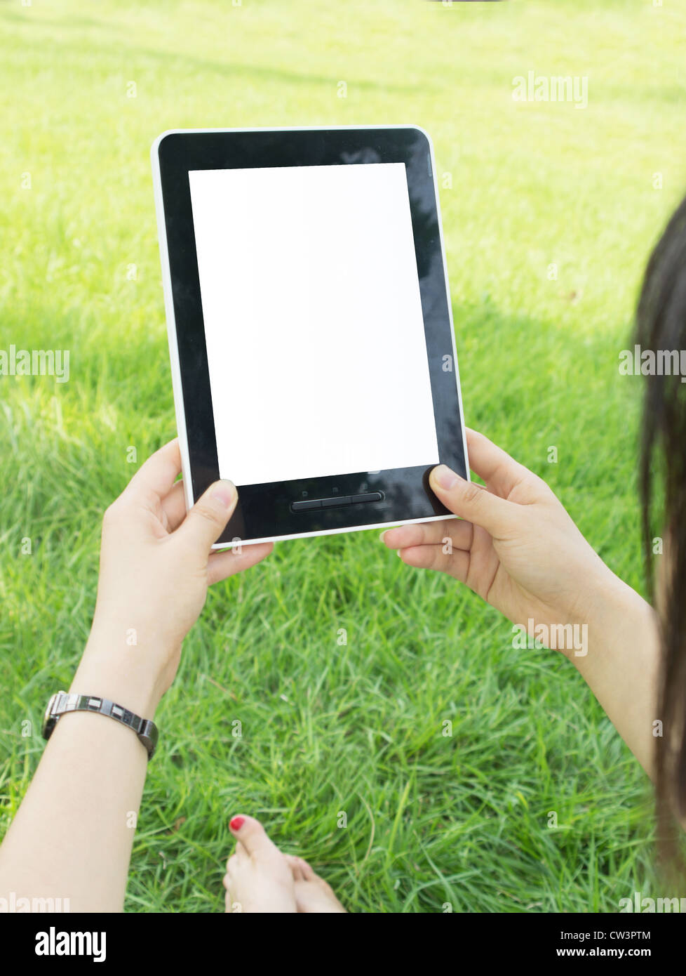 Woman hands holding electronic tablet pc with blank screen. Stock Photo