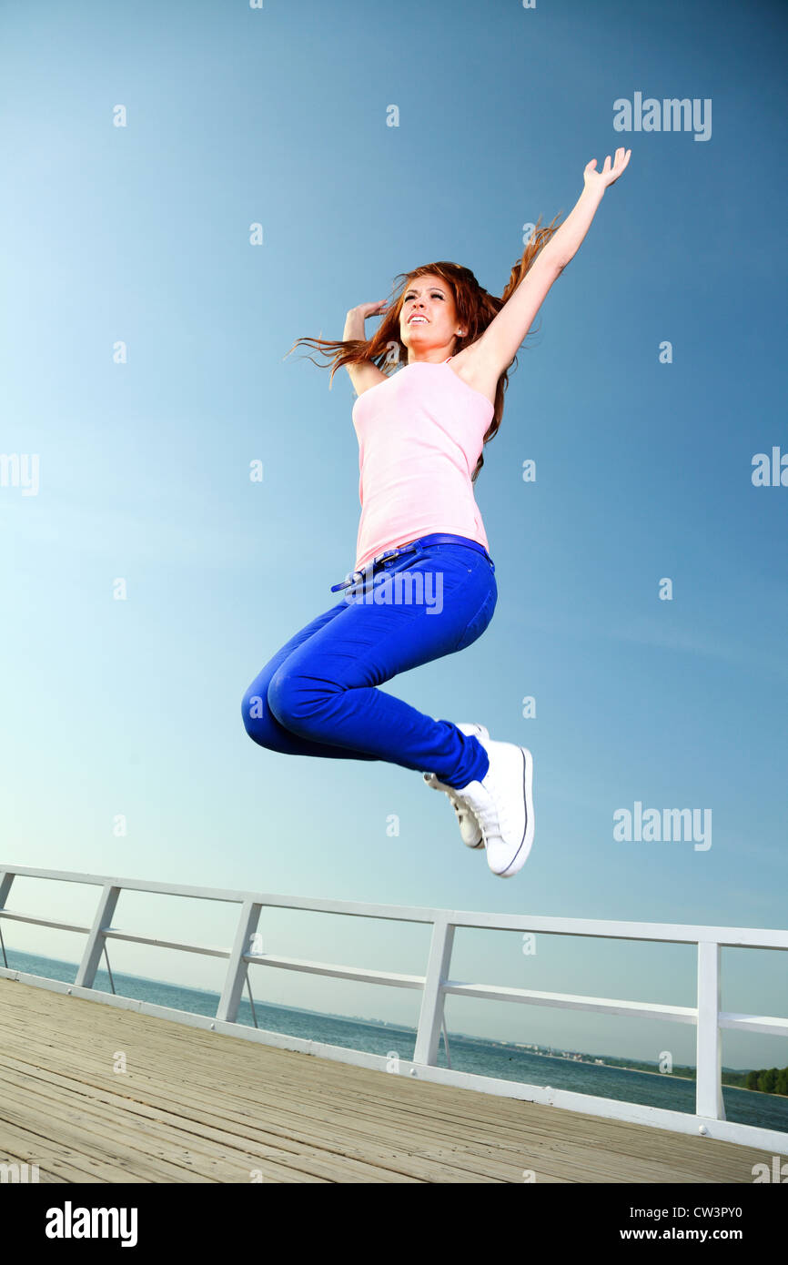 Attractive girl Young woman jumping in the sky Stock Photo - Alamy