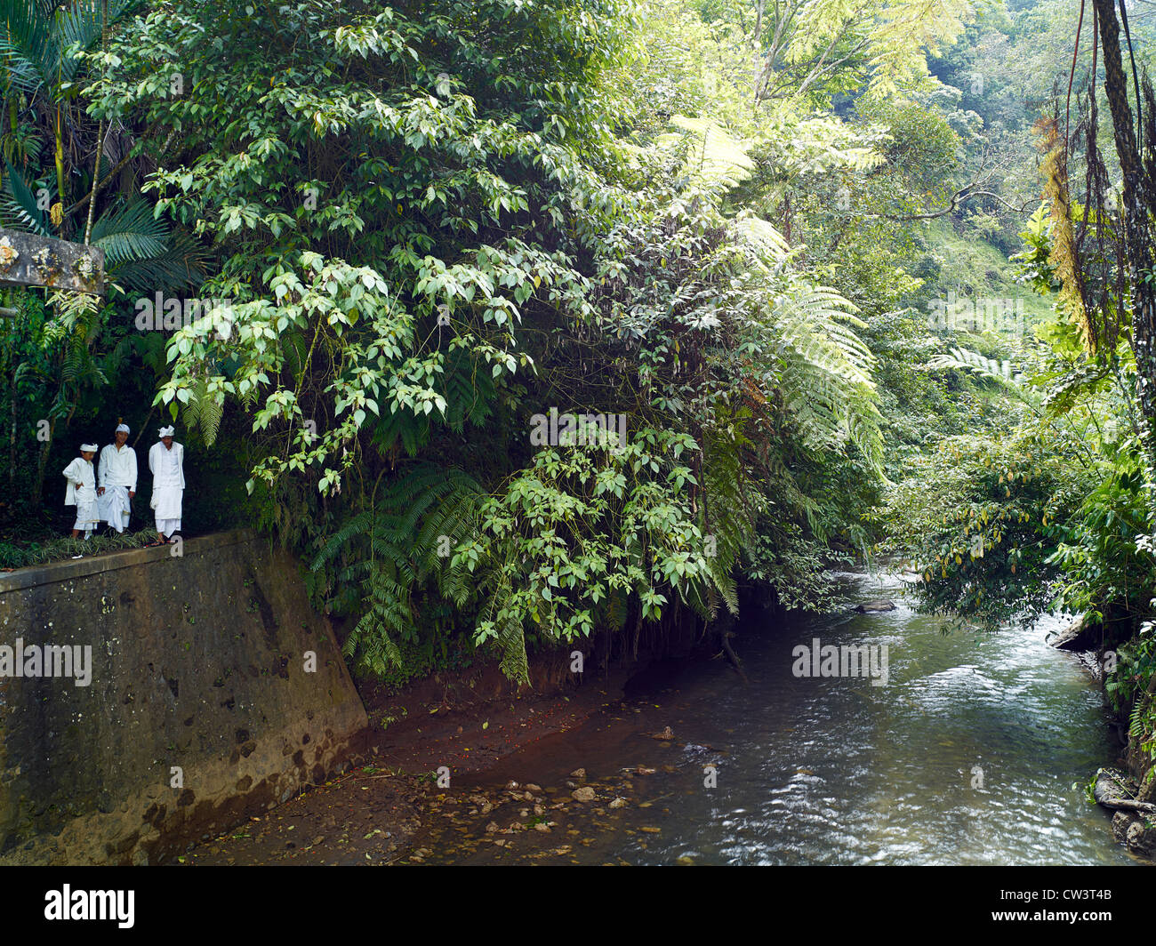 Priests pray by the side of a water irrigation dam Stock Photo