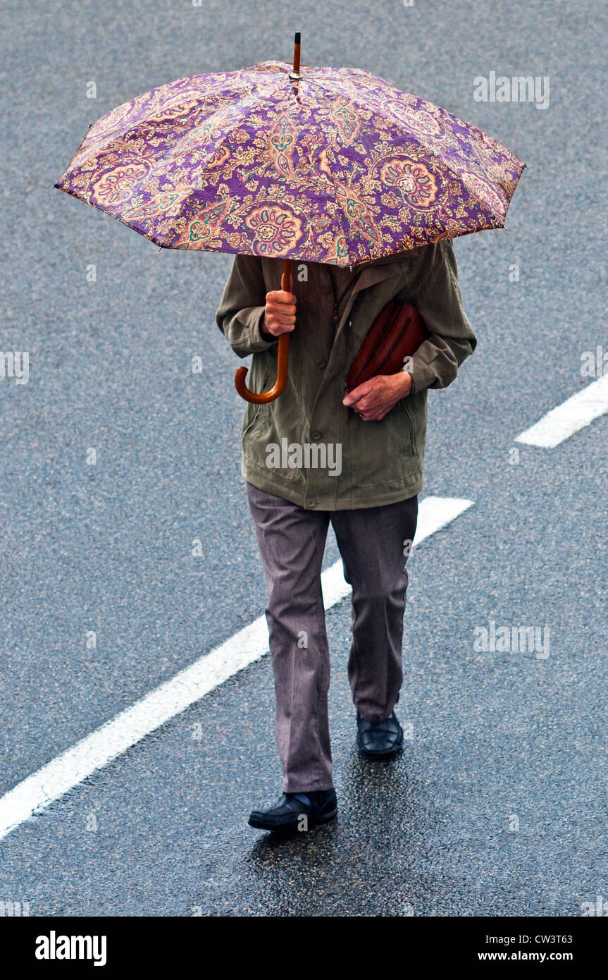 Man walking with umbrella hires stock photography and images Alamy