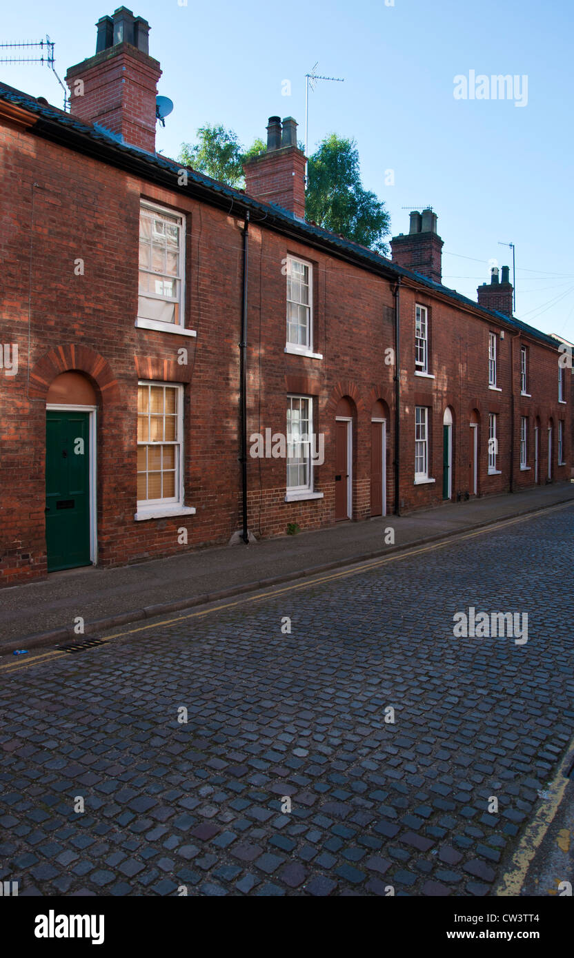 Row of red brick Victorian terraced houses with cobbled Calvert Street