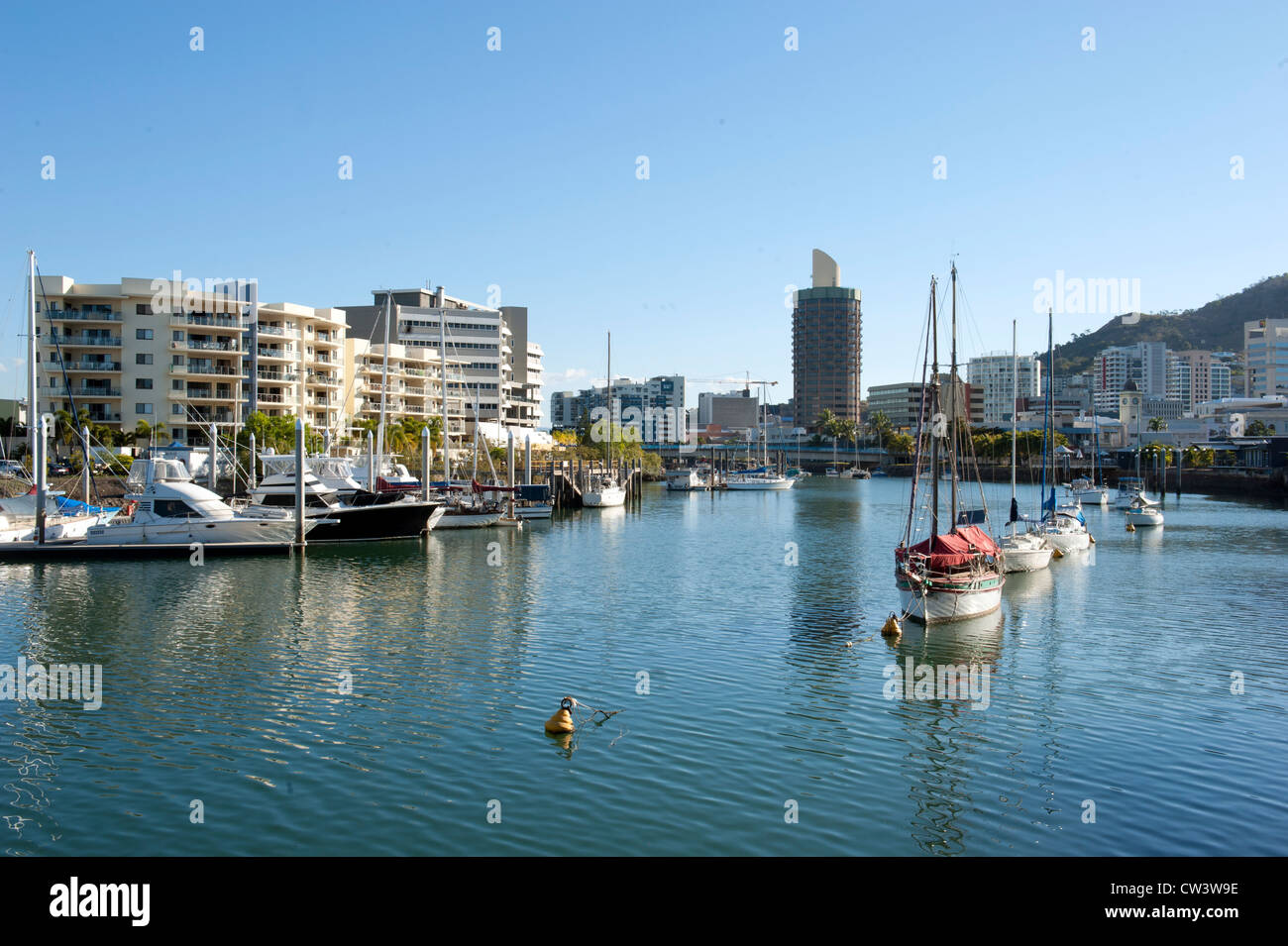 Motor boats, yachts, and sail boats moored in the Ross river, flowing through the CBD of Townsville, tropical North Queensland Stock Photo