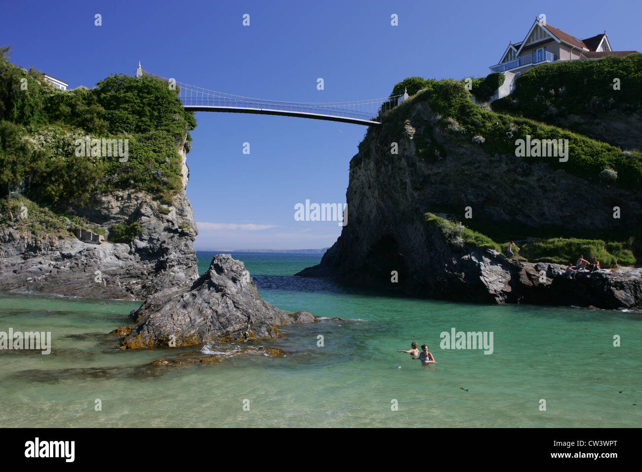 kids play in the sea at newquay the bridge leads to the The House in
