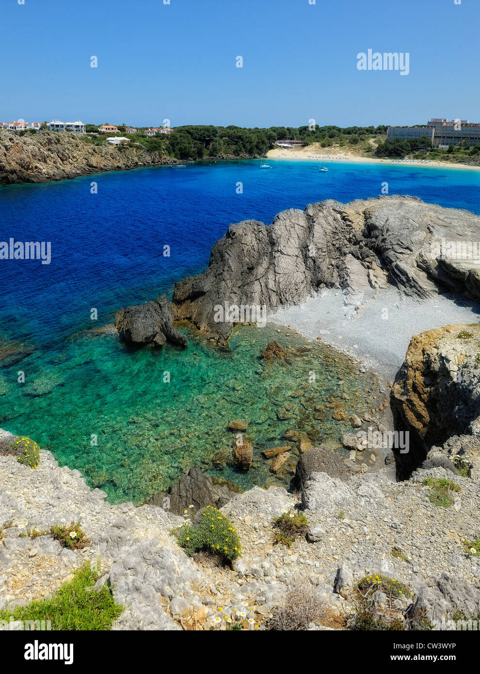 secluded pebble beach arenal d'en castell Menorca Spain Stock Photo