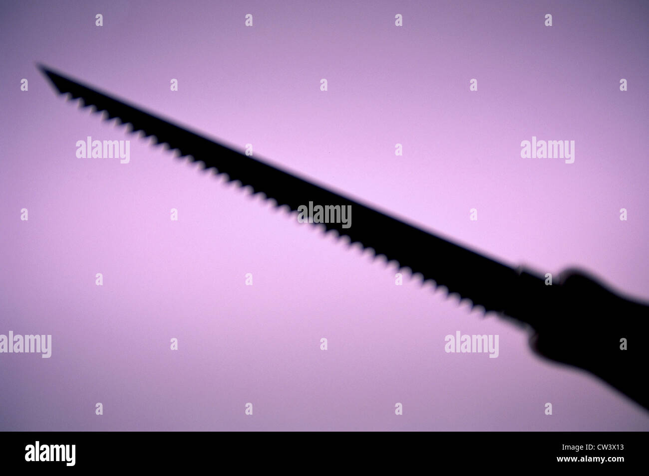 Silhouette of a hand saw Stock Photo