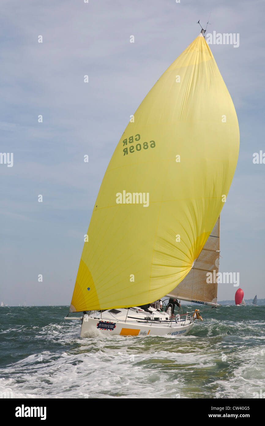 Yacht 6809R Willis  with yellow sail racing at Cowes Isle of Wight Stock Photo