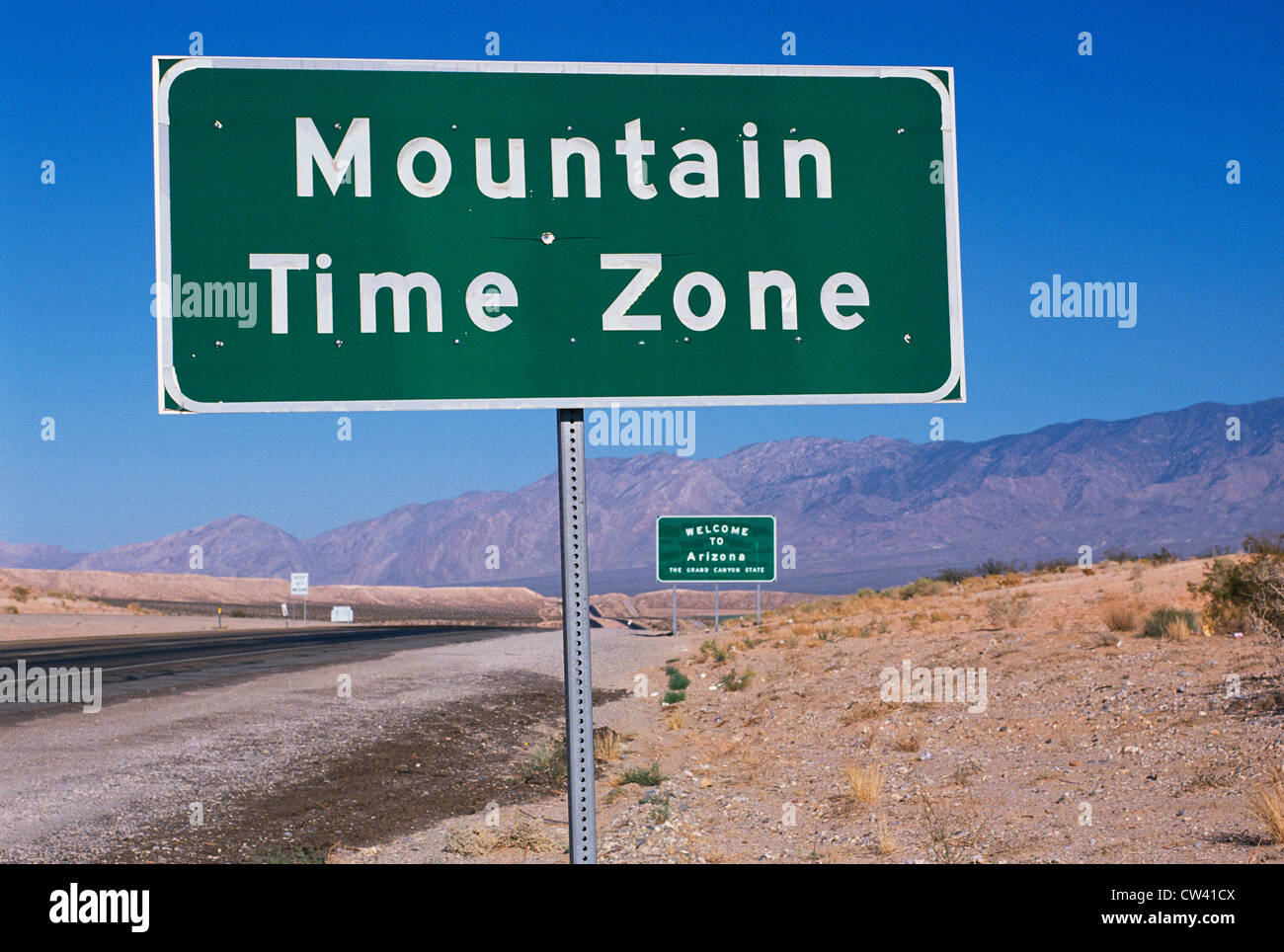 This is a road sign indicating a change to the Mountain Time Zone. The