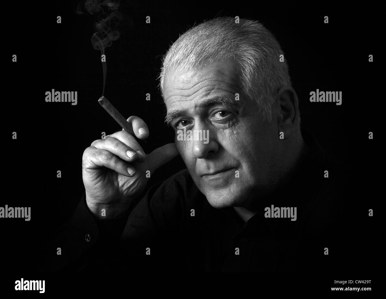 Portrait of a mature male with gray hair smoking a cigar Stock Photo - Alamy