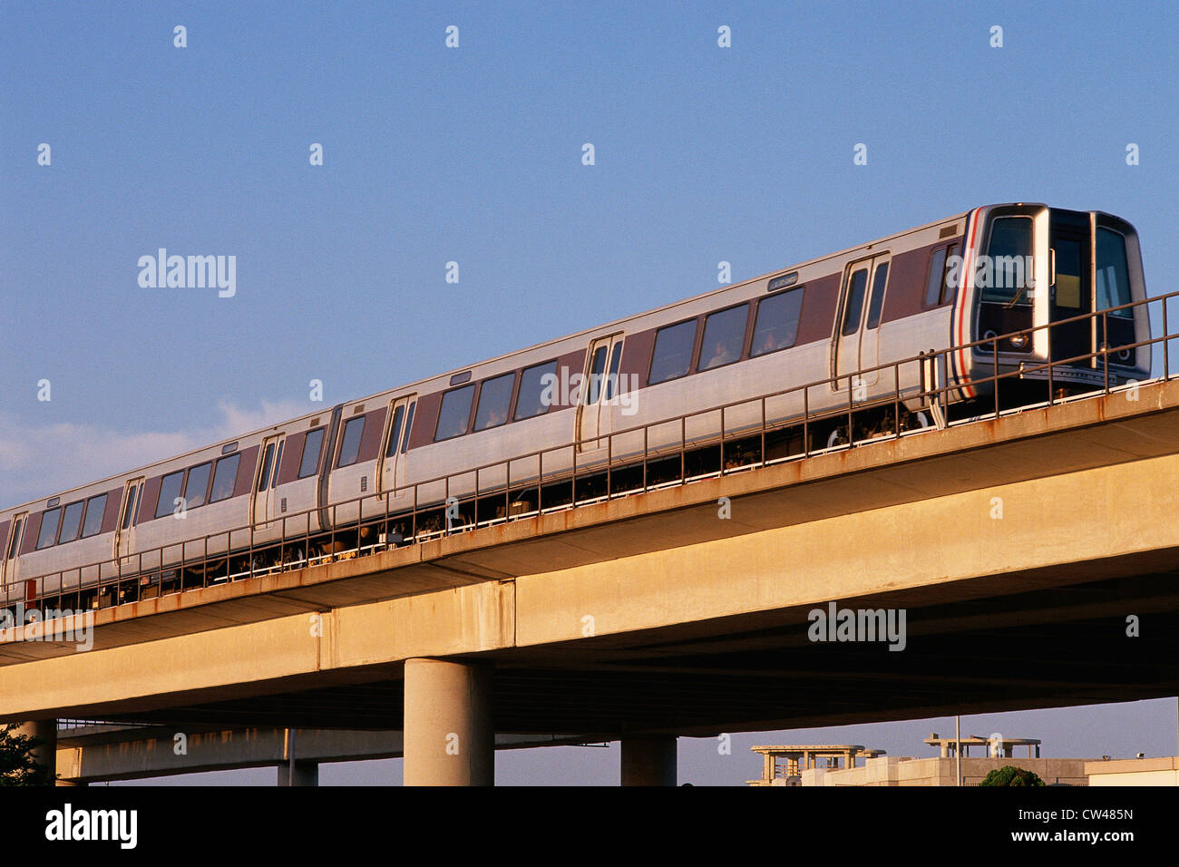 Commuter train on elevated track Stock Photo - Alamy