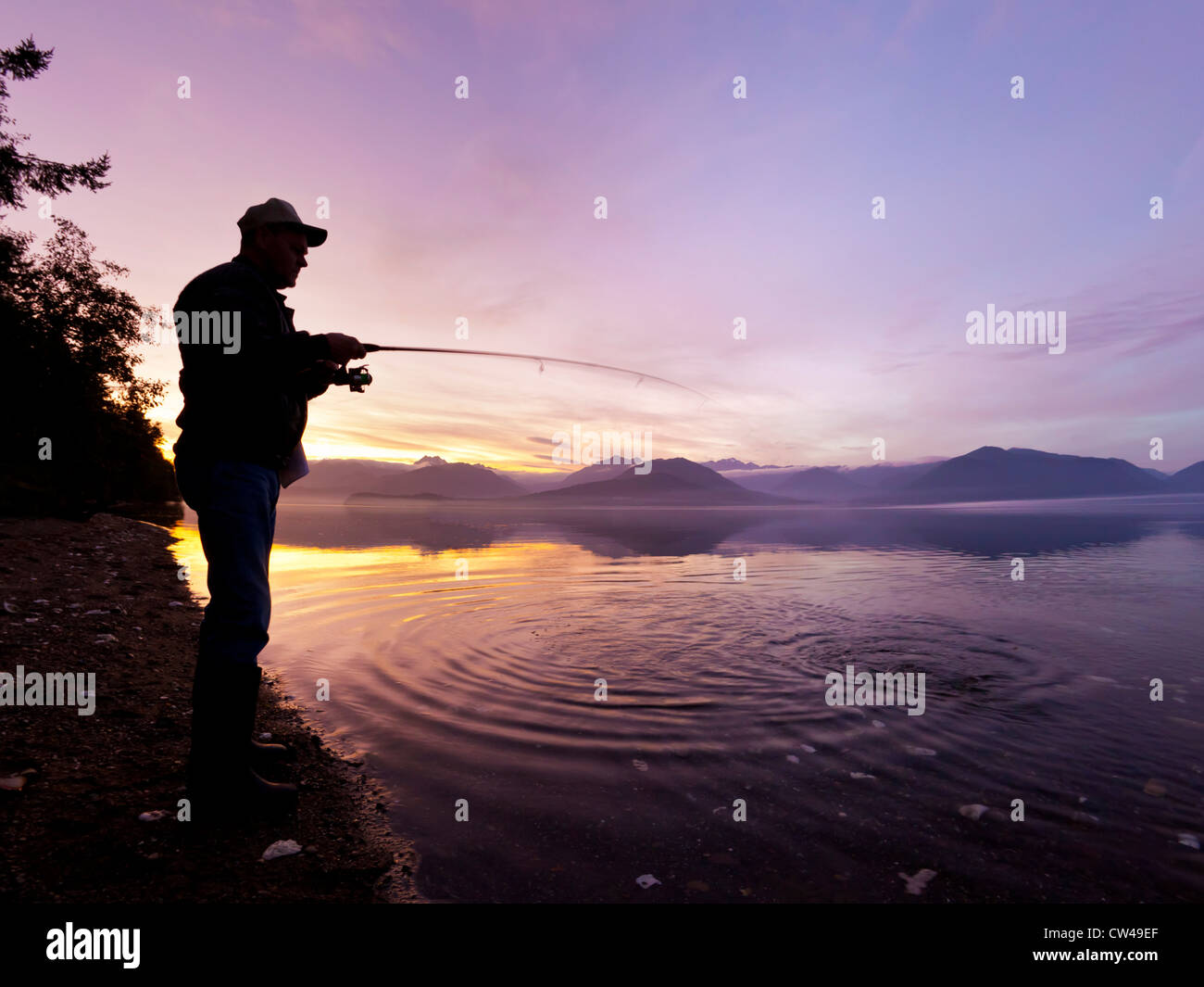 Man wearing cowboy hat checks net for catch before casting into surf on  Mendocino California coast Stock Photo - Alamy