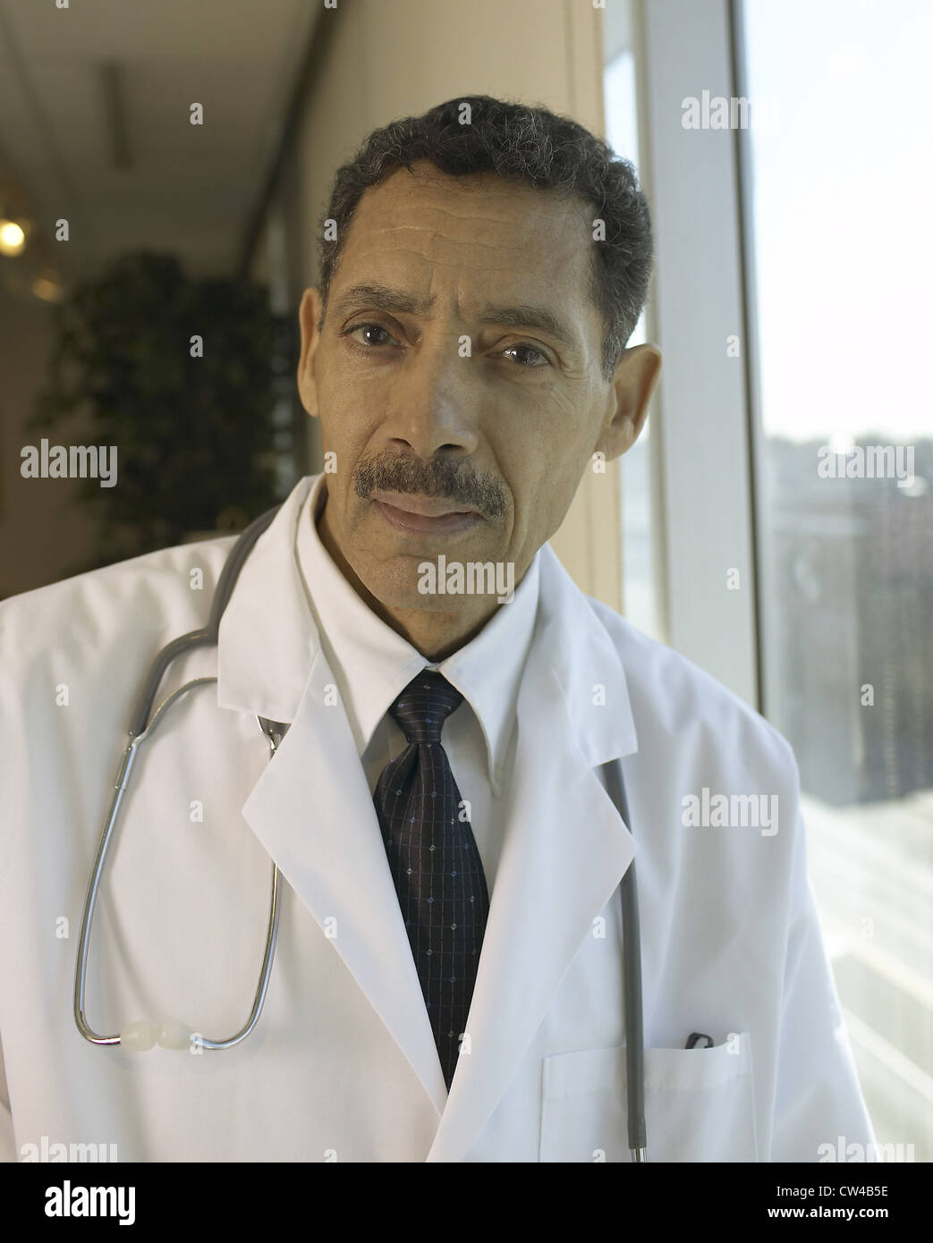 Portrait of a male doctor smiling Stock Photo - Alamy