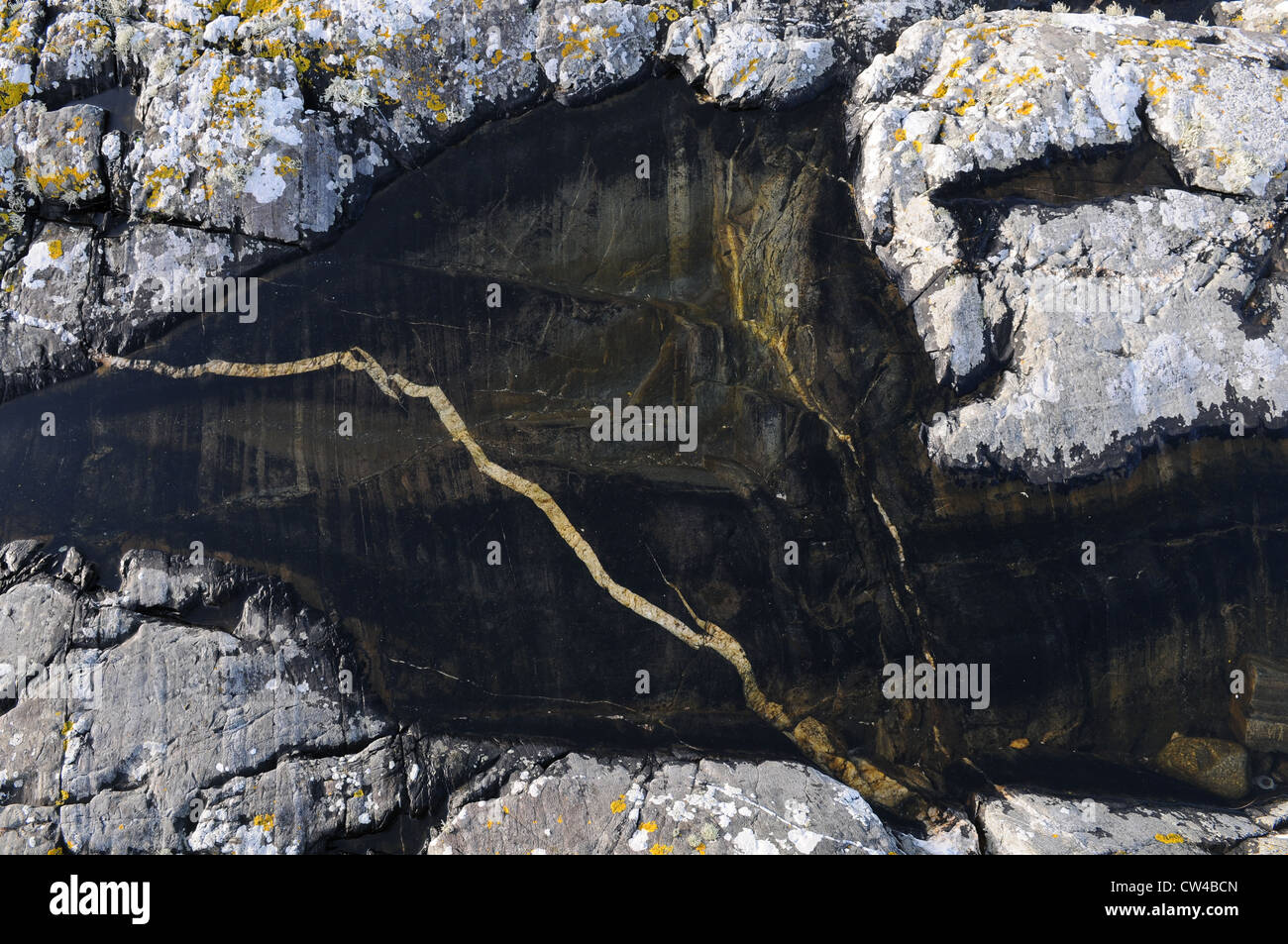 Rock pool with a white vain running through black stone, Lettermullan, Conamara, County Galway, Ireland Stock Photo