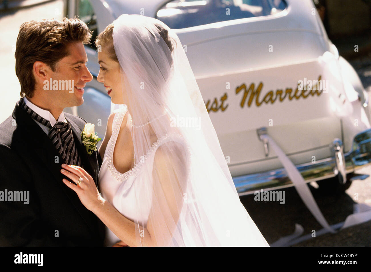 Smiling bride touching veil hi-res stock photography and images - Alamy