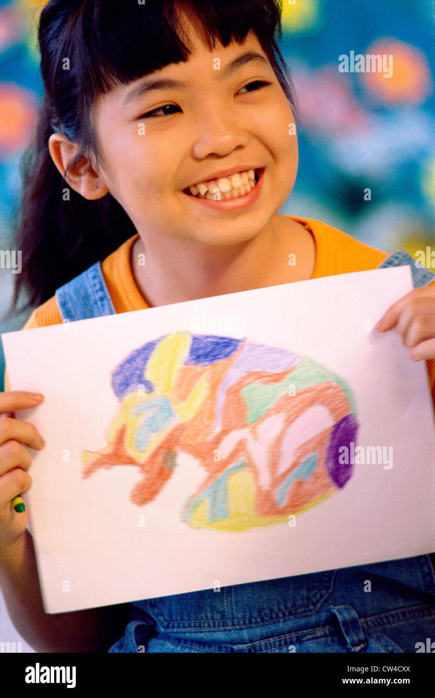 Close-up of a girl holding a painting Stock Photo