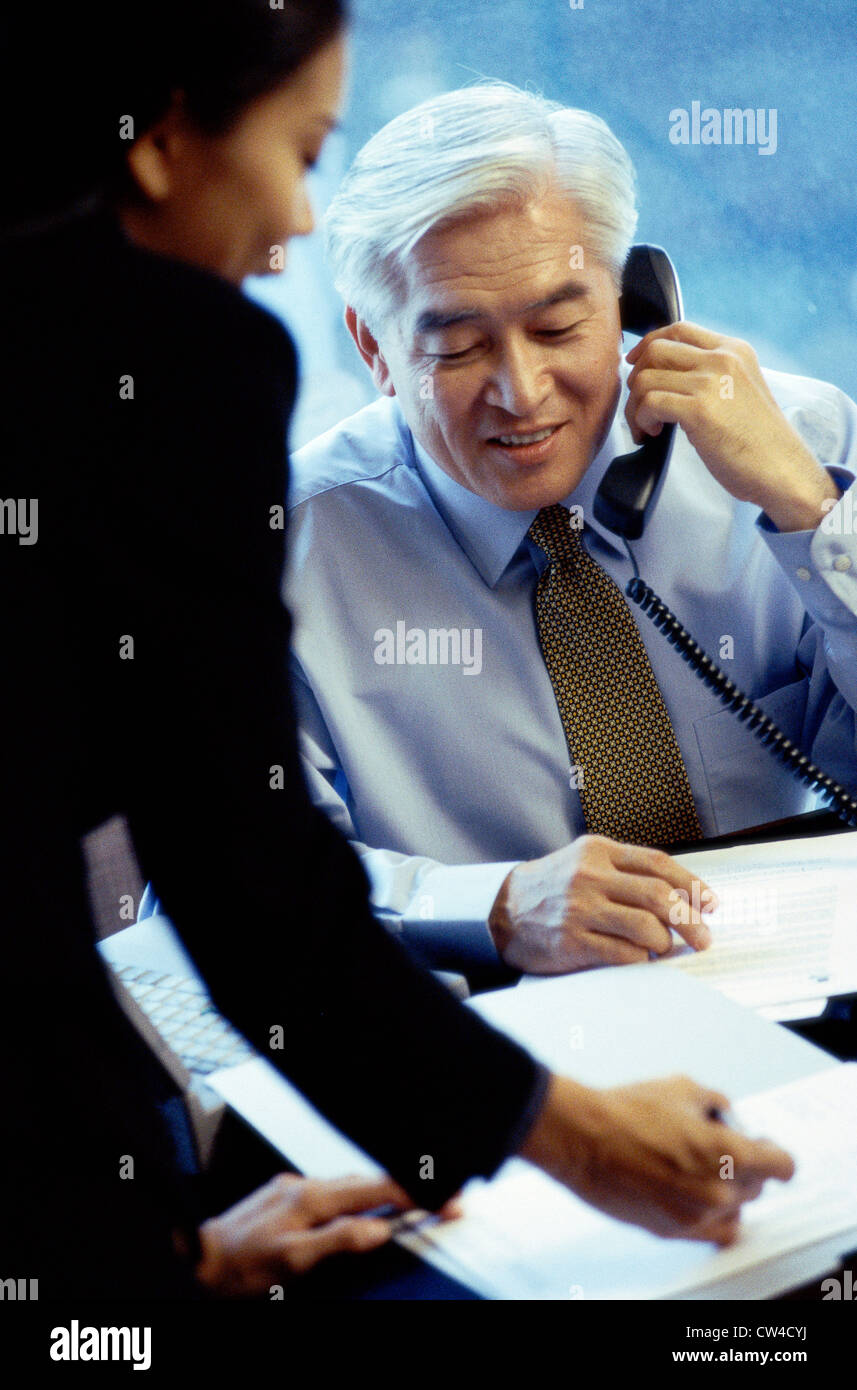 Businessman and a businesswoman in an office Stock Photo - Alamy