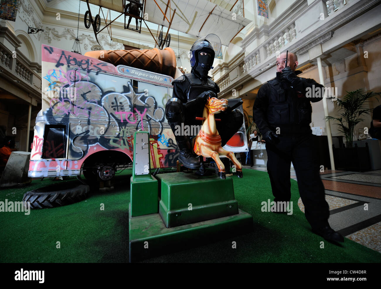 The 'Banksy Versus Bristol Museum' exhibition June 2009 - Riot policeman riding a fairground horse Stock Photo