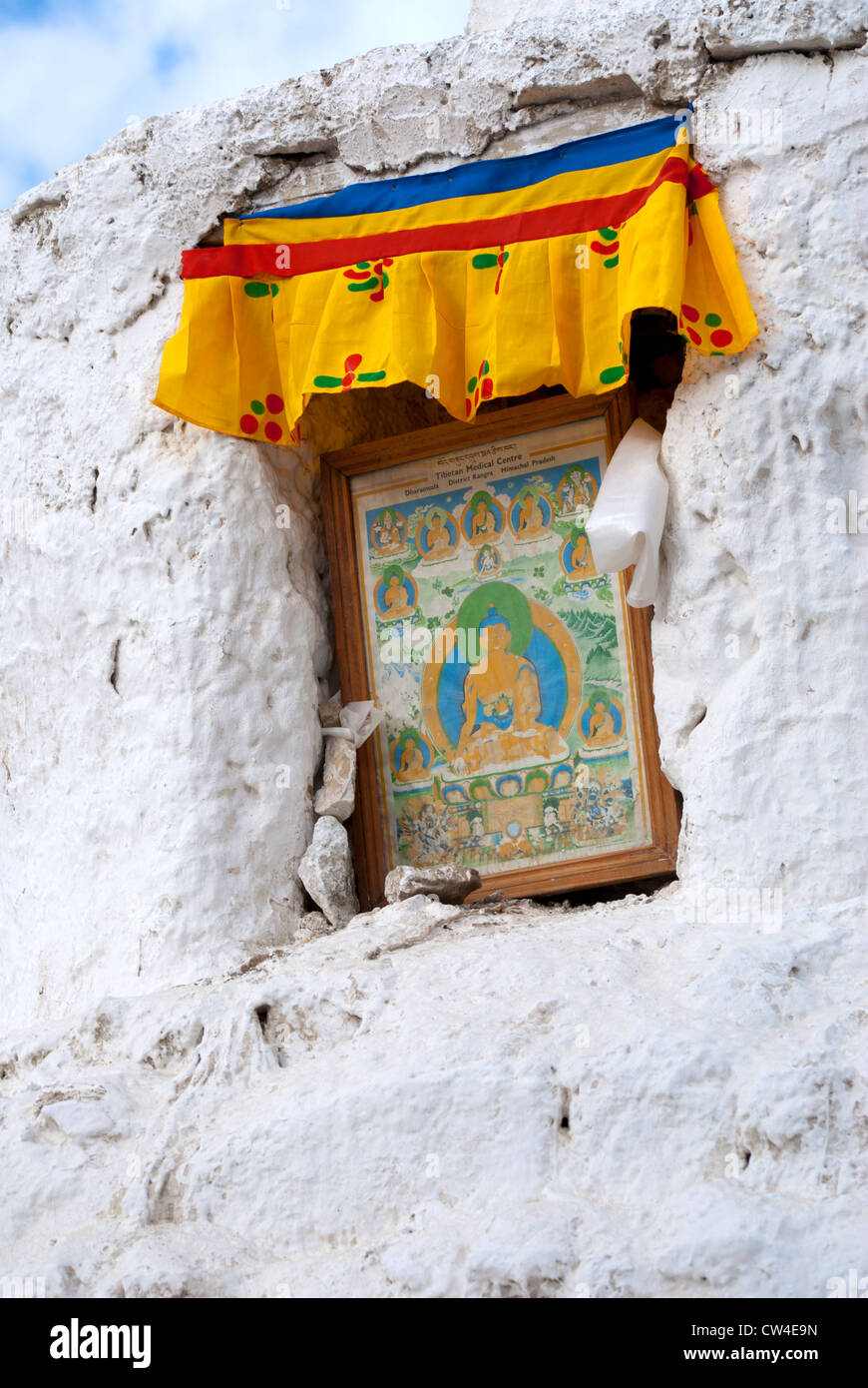 Window in a wall of Leh monastery with a ruffled curtain and a picture of Buddha in it in Leh, Ladakh, India Stock Photo