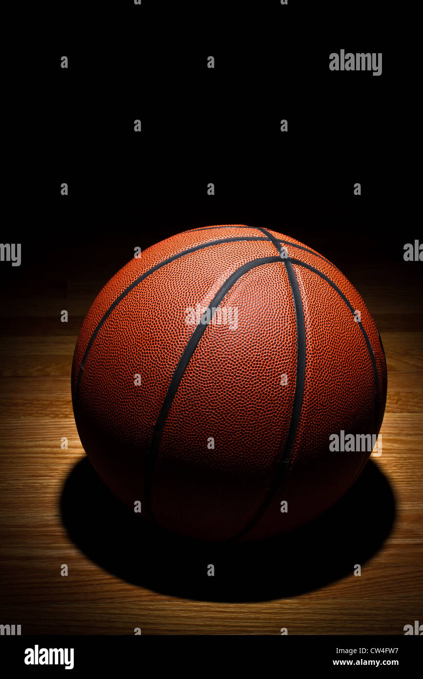 Basketball on wood court Stock Photo