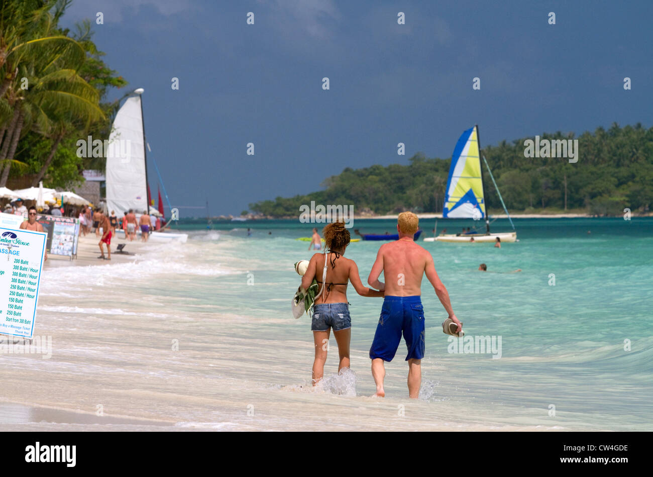 People walk hand in hand along the Gulf of Thailand at Chaweng beach on the island of Ko Samui, Thailand. Stock Photo