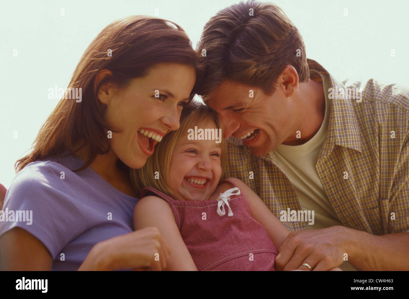 Close-up of parents and their daughter laughing Stock Photo
