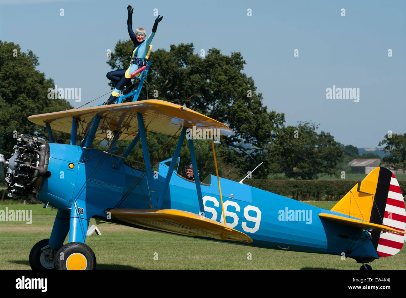 Person Wingwalking On A Vintage Boeing PT-17 Stearman Bi Plane Stock Photo