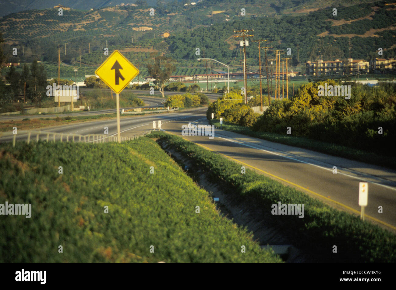 A merge sign on a highway Stock Photo - Alamy