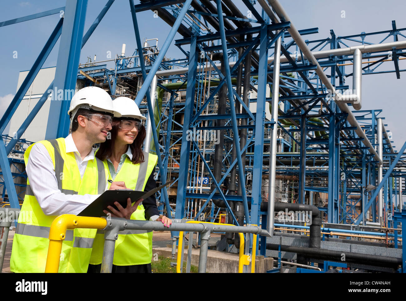technicians working in industrial chemical plant, norfolk, england
