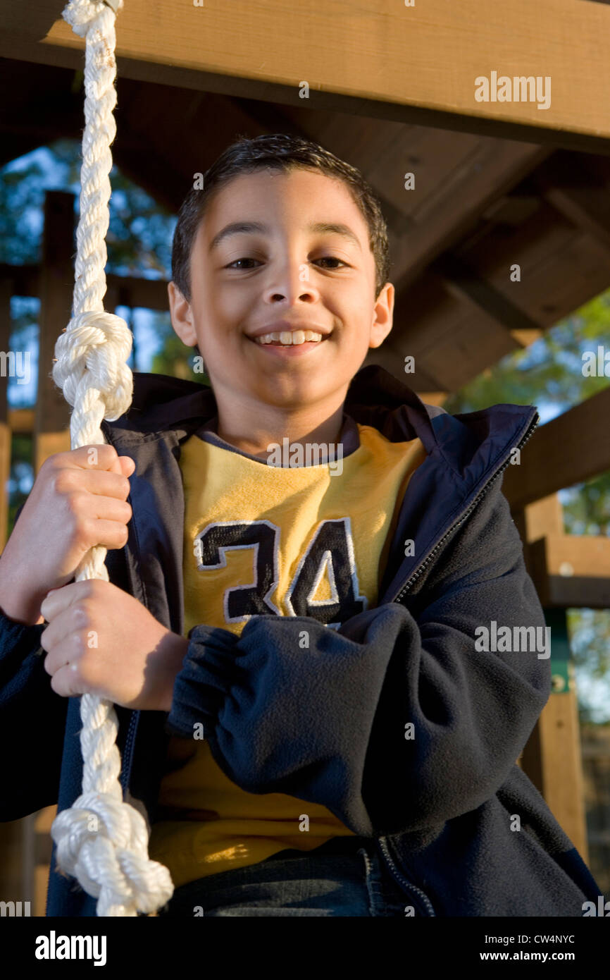 Portrait of a cheerful boy playing with a rope Stock Photo - Alamy
