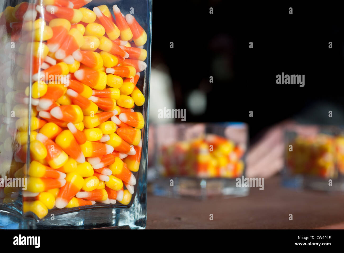 3 jars of candy corn set out on a table. Stock Photo
