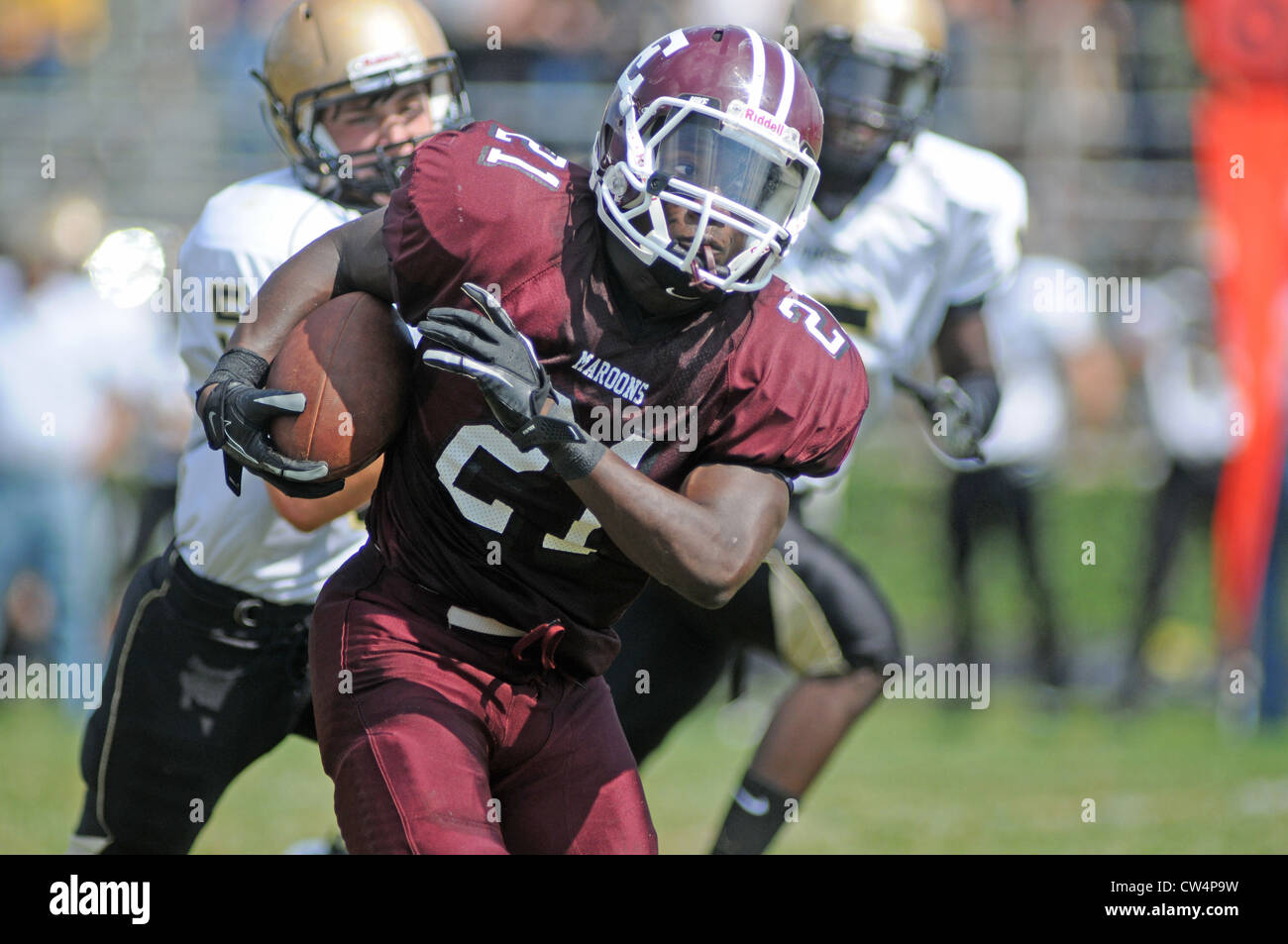 Football running back with a protective eye shield during a high school game. USA. Stock Photo