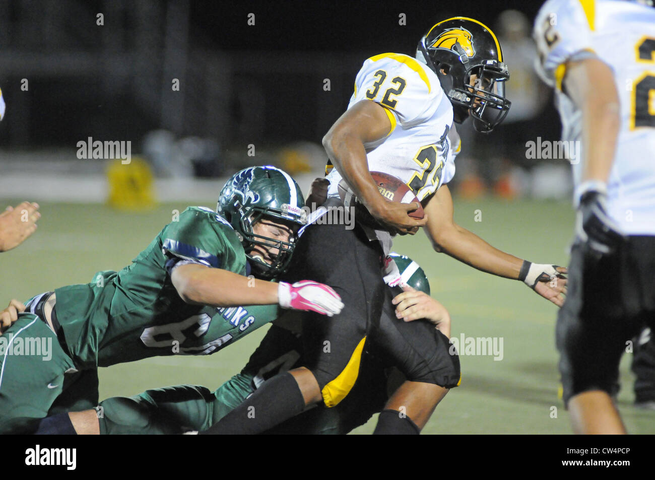 Football Defensive tackle brings down running back from behind during a high school game. USA