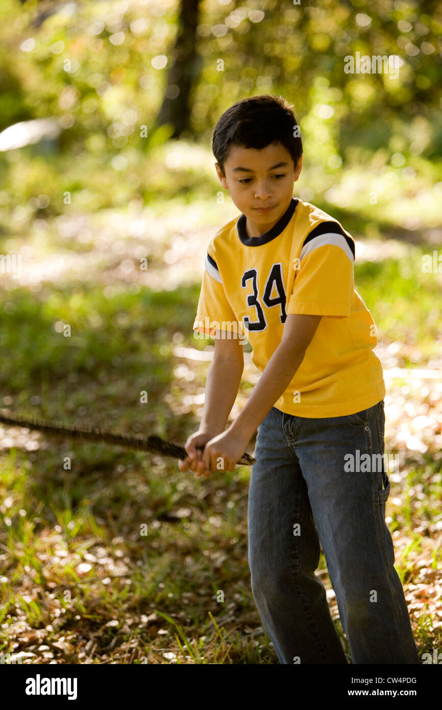 Boy holding a stick hi-res stock photography and images - Alamy