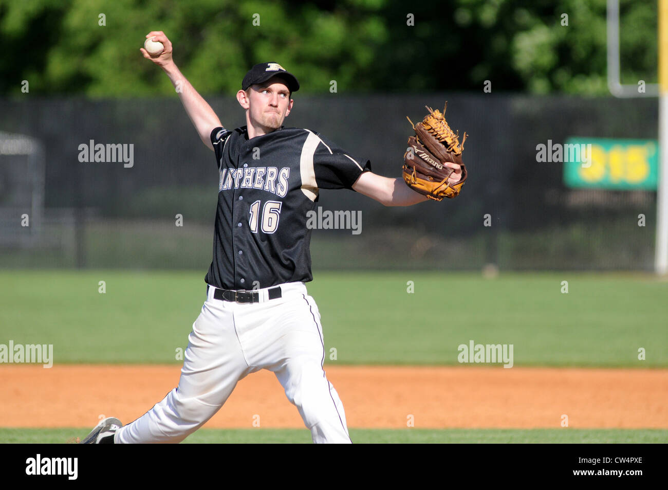 Baseball Pitcher in middelivery as he releases a pitch during a high school playoff game. USA